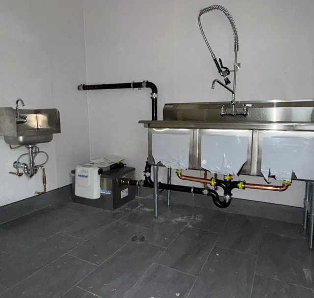 Commercial kitchen three-bay sink and hand sink