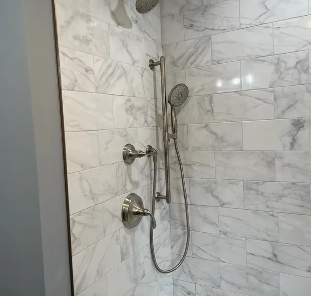 Marble tile shower with brushed nickel fixtures